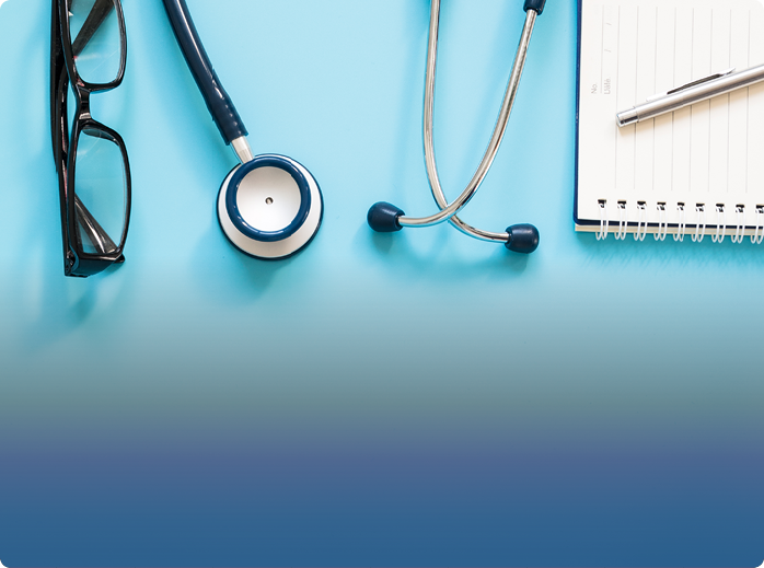 a stethoscope glasses a pen and a notebook on a blue background