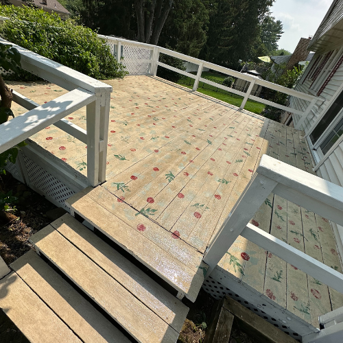 A wooden deck with flowers painted on it