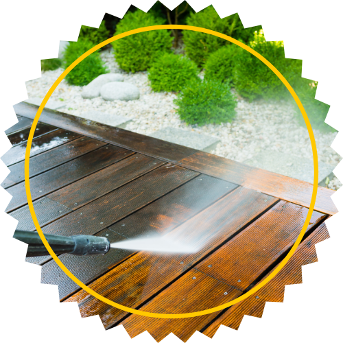 A high pressure washer is spraying water on a wooden deck