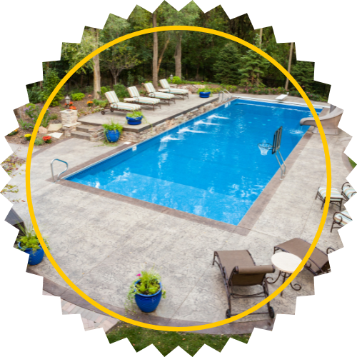 A large swimming pool is surrounded by chairs and plants