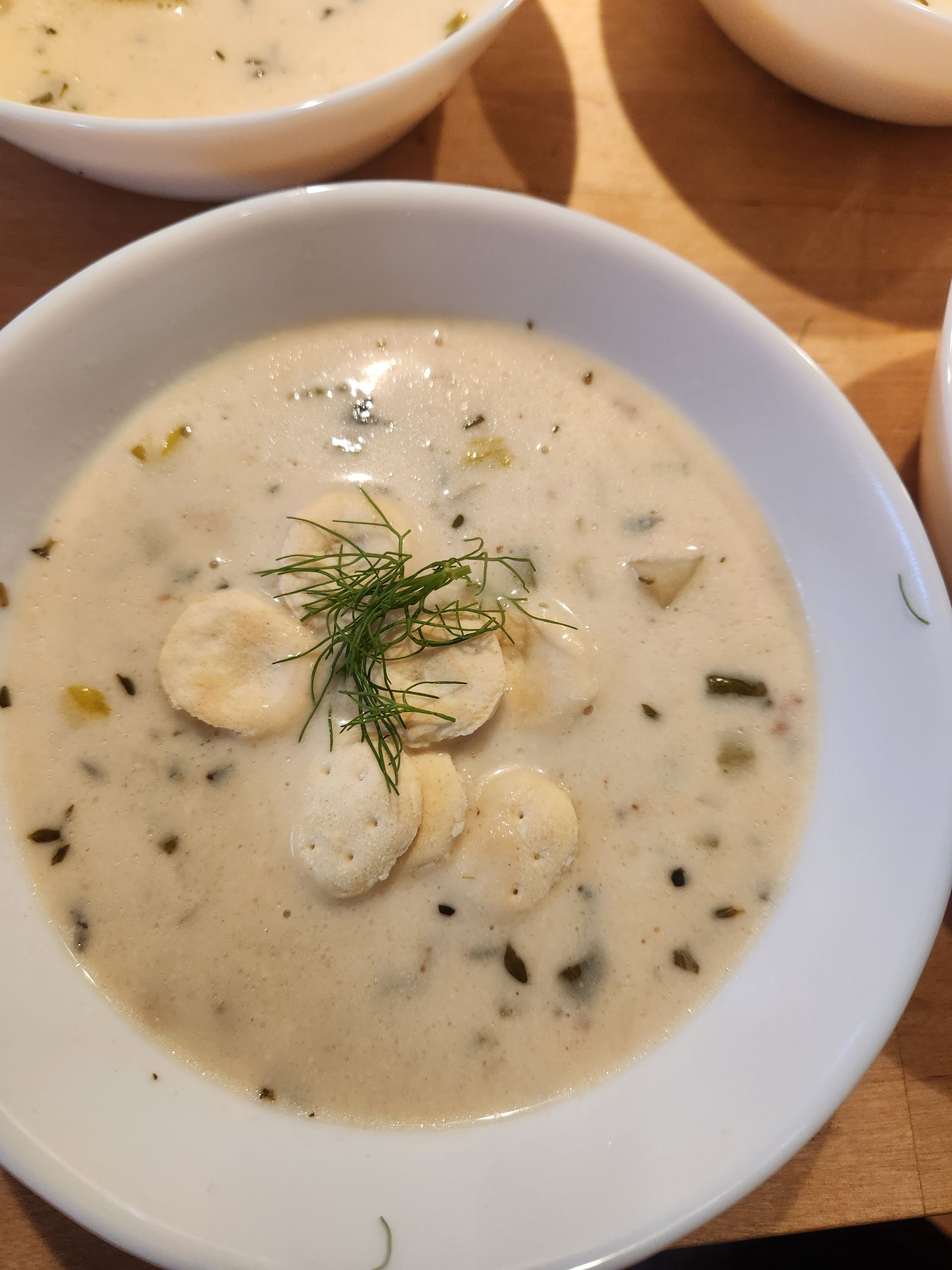A close up of a bowl of soup on a table.