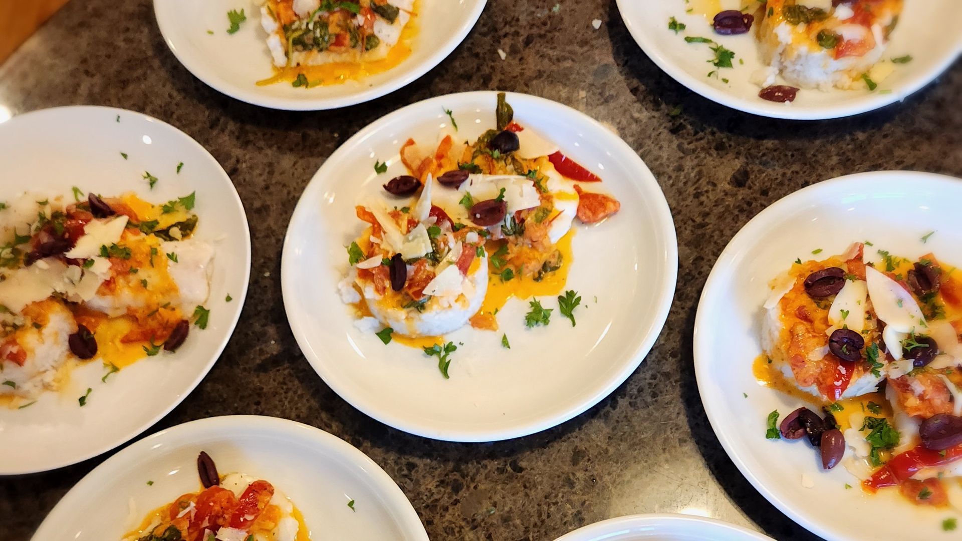 Several plates of food are sitting on a table.