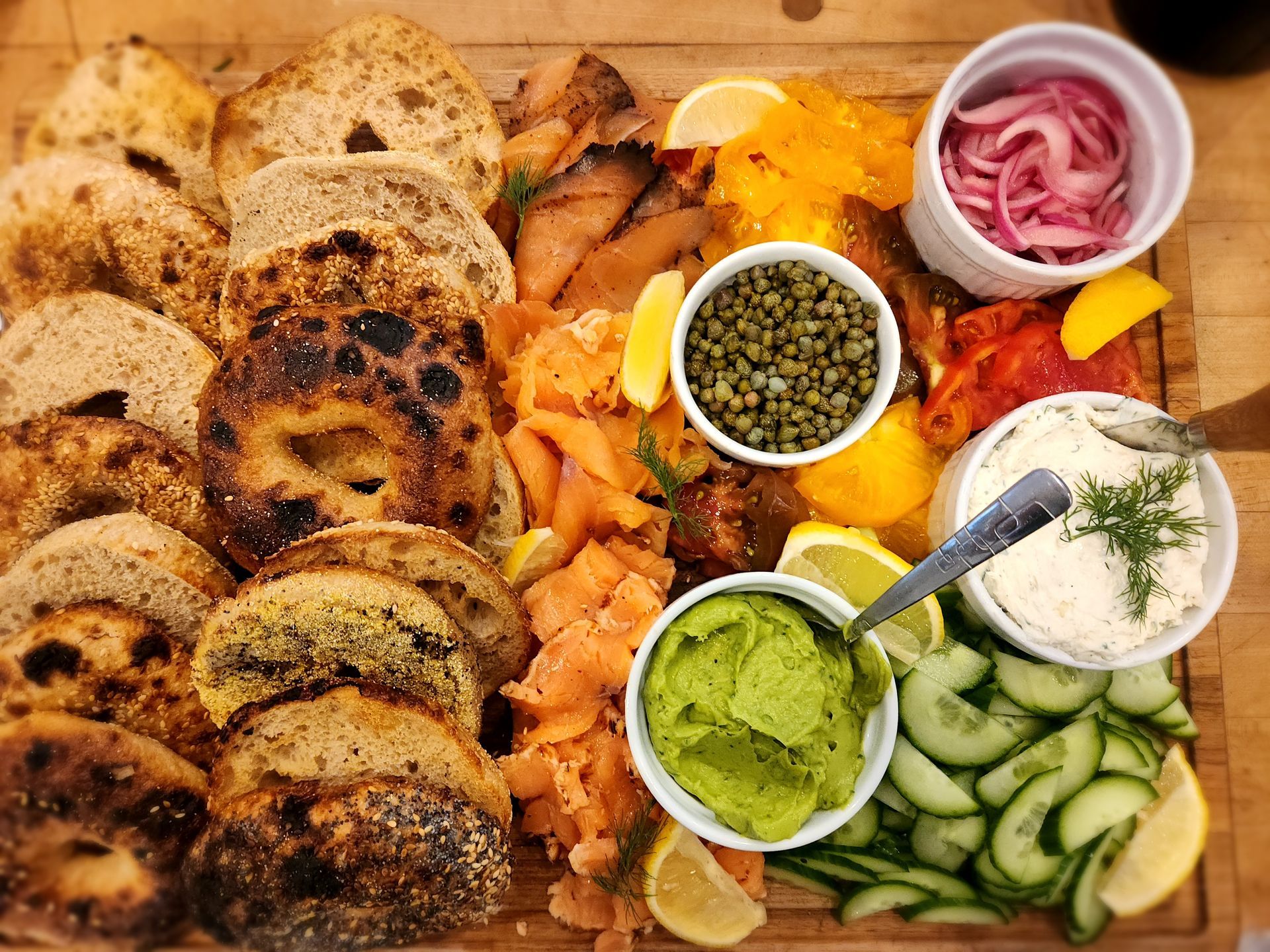 A wooden cutting board with a variety of food on it