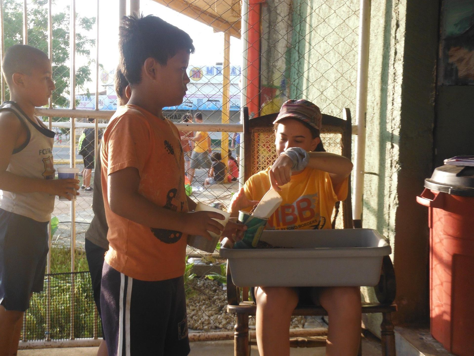 A boy in a yellow shirt with the letter bb on it