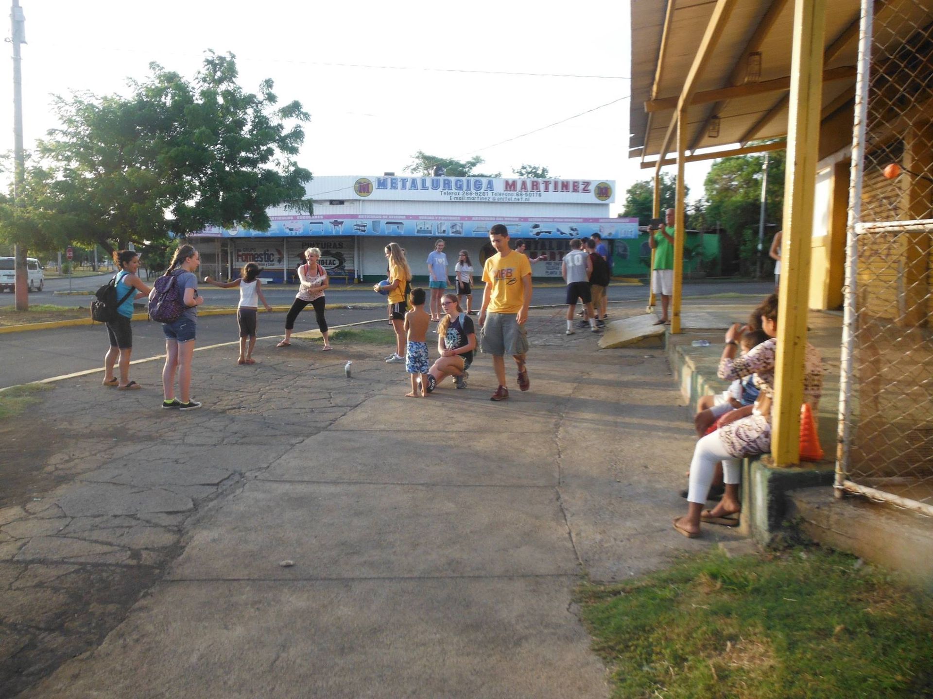 A group of people are gathered on a sidewalk in front of a building that has the word maritime on it