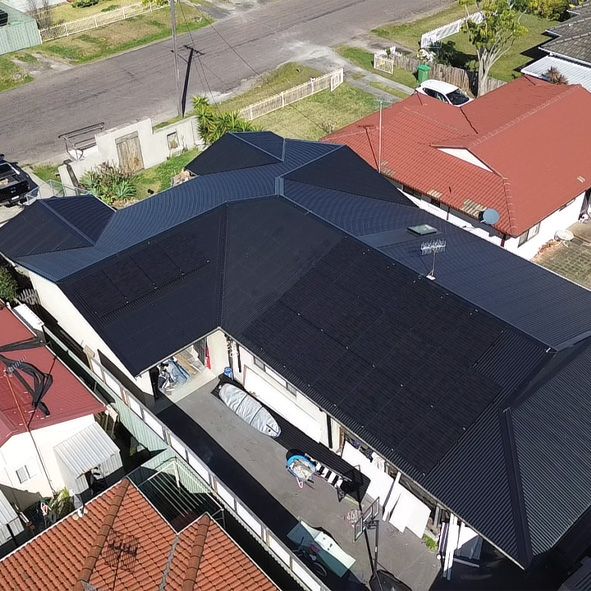 An Aerial View of a House With a Black Roof and a Red Roof — DLG Electrical & Solar In Wyong, NSW