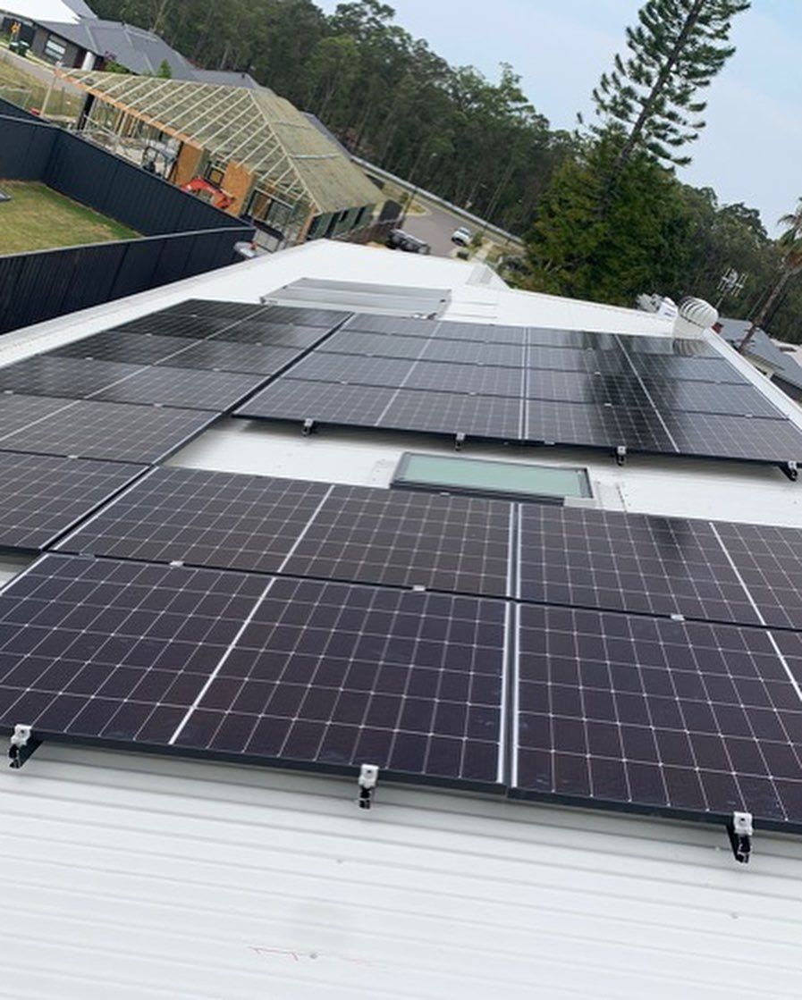 There Are Many Solar Panels on the Roof of a House — DLG Electrical & Solar In Wyong, NSW