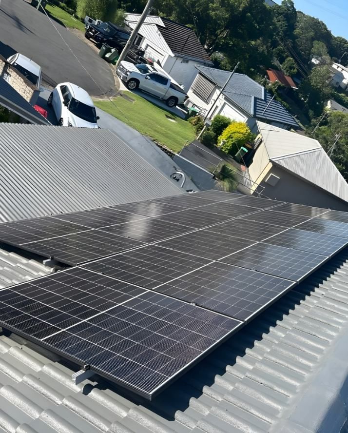 A Row of Solar Panels on the Roof of a House — DLG Electrical & Solar In Wyong, NSW