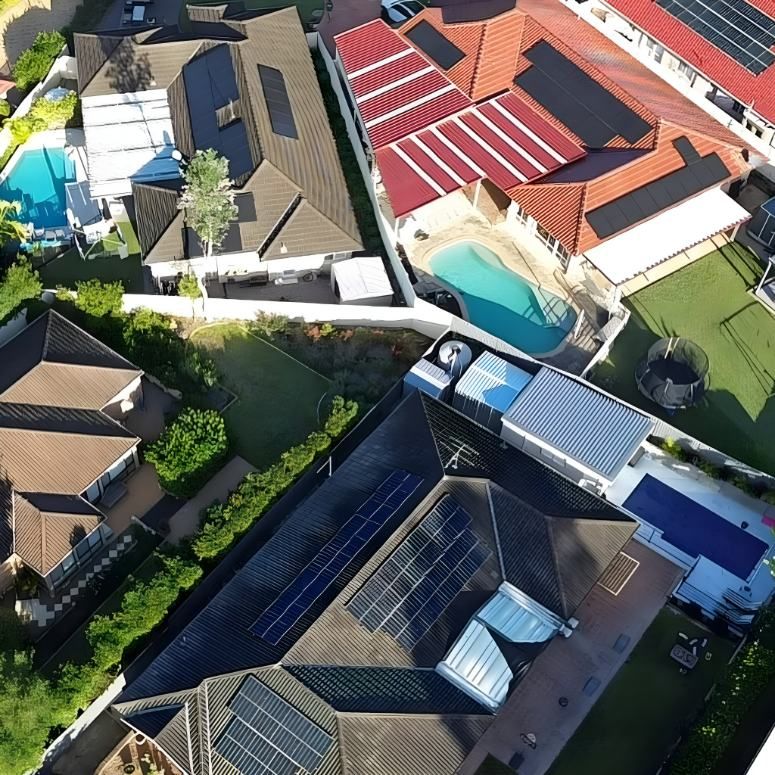 An Aerial View of a Residential Area With Solar Panels on the Roofs — DLG Electrical & Solar In Newcastle, NSW