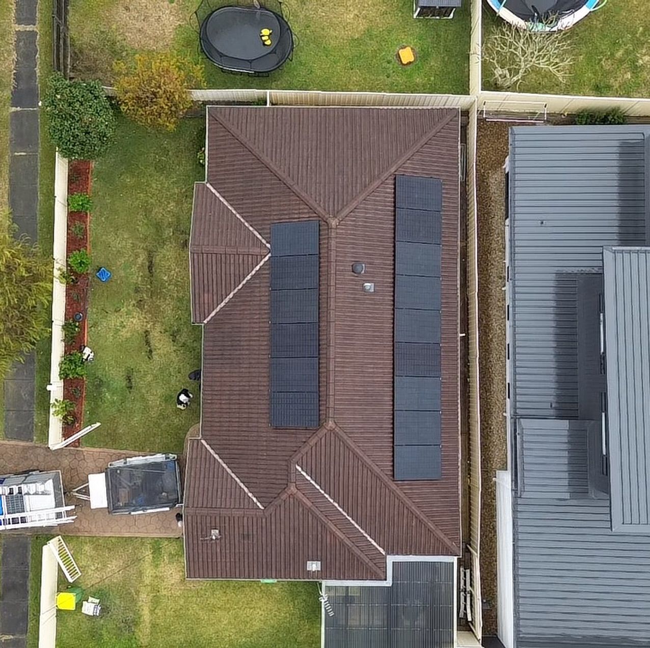 A House With Solar Panels on the Roof — DLG Electrical & Solar In Wyong, NSW