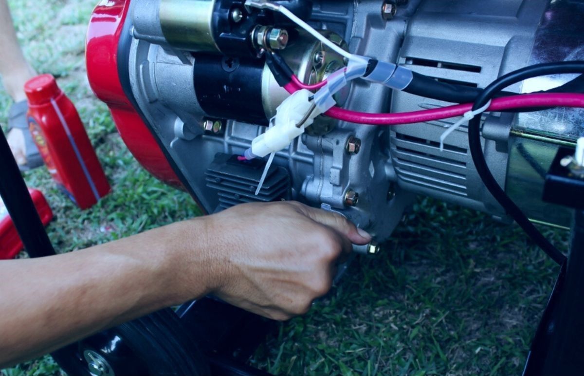 A Person is Working on a Generator With a Pair of Pliers — DLG Electrical & Solar In Hunter Valley, NSW