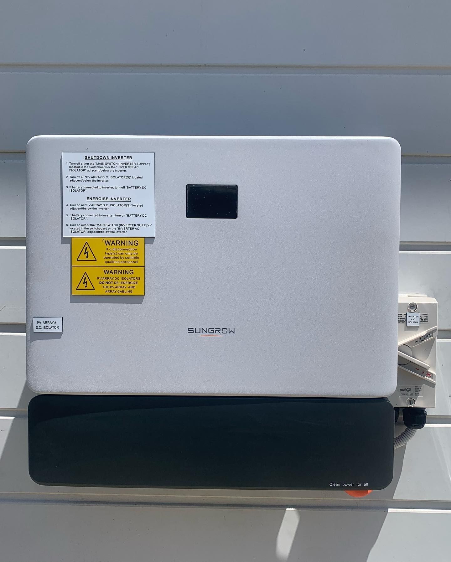 A White Box With a Yellow Warning Label on It — DLG Electrical & Solar In Port Stephens, NSW