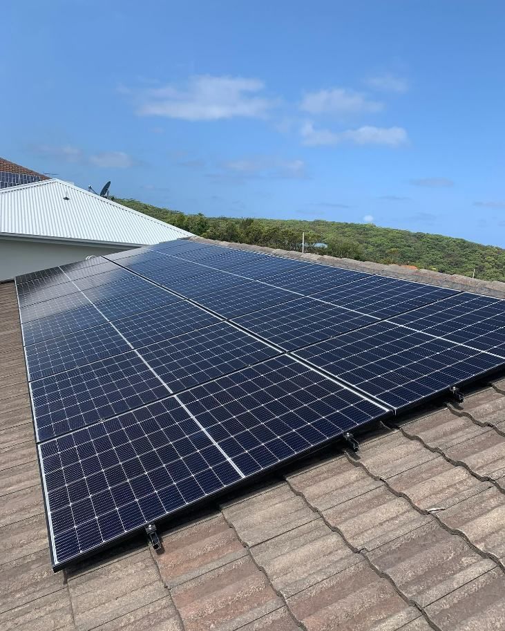 There Are Many Solar Panels on the Roof of a House — DLG Electrical & Solar In Port Stephens, NSW