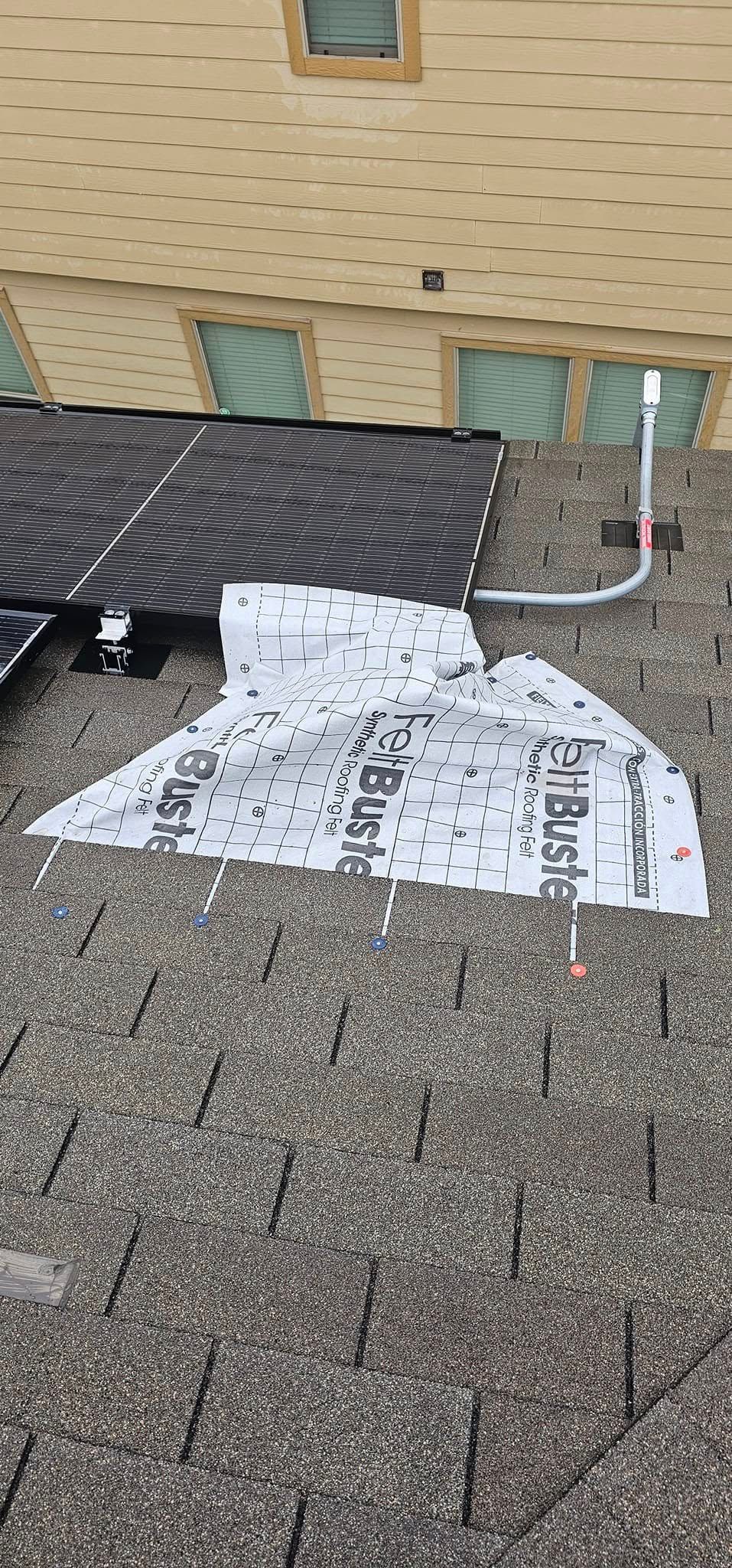 A piece of paper is laying on top of a roof.