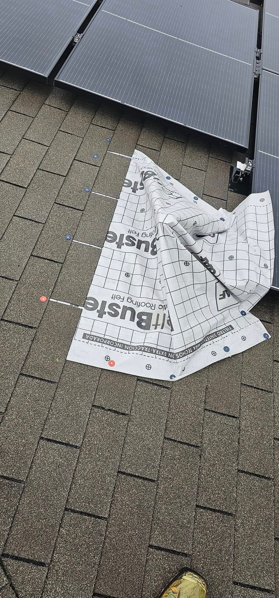A piece of paper is laying on the ground next to a solar panel.