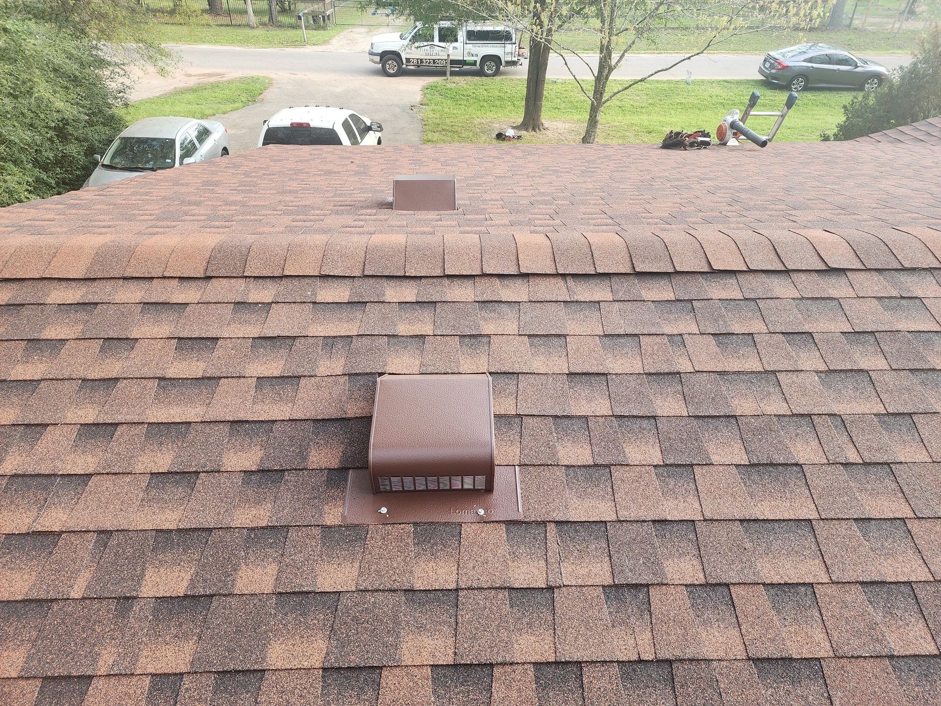A roof with shingles and a chimney on it