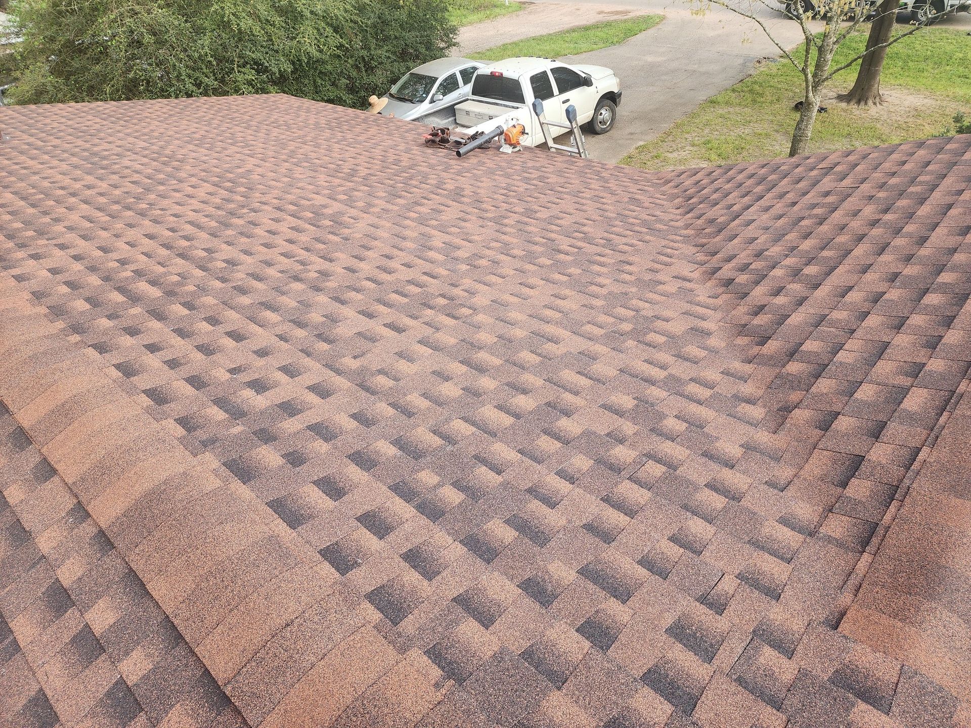 Two cars are parked on the roof of a house.