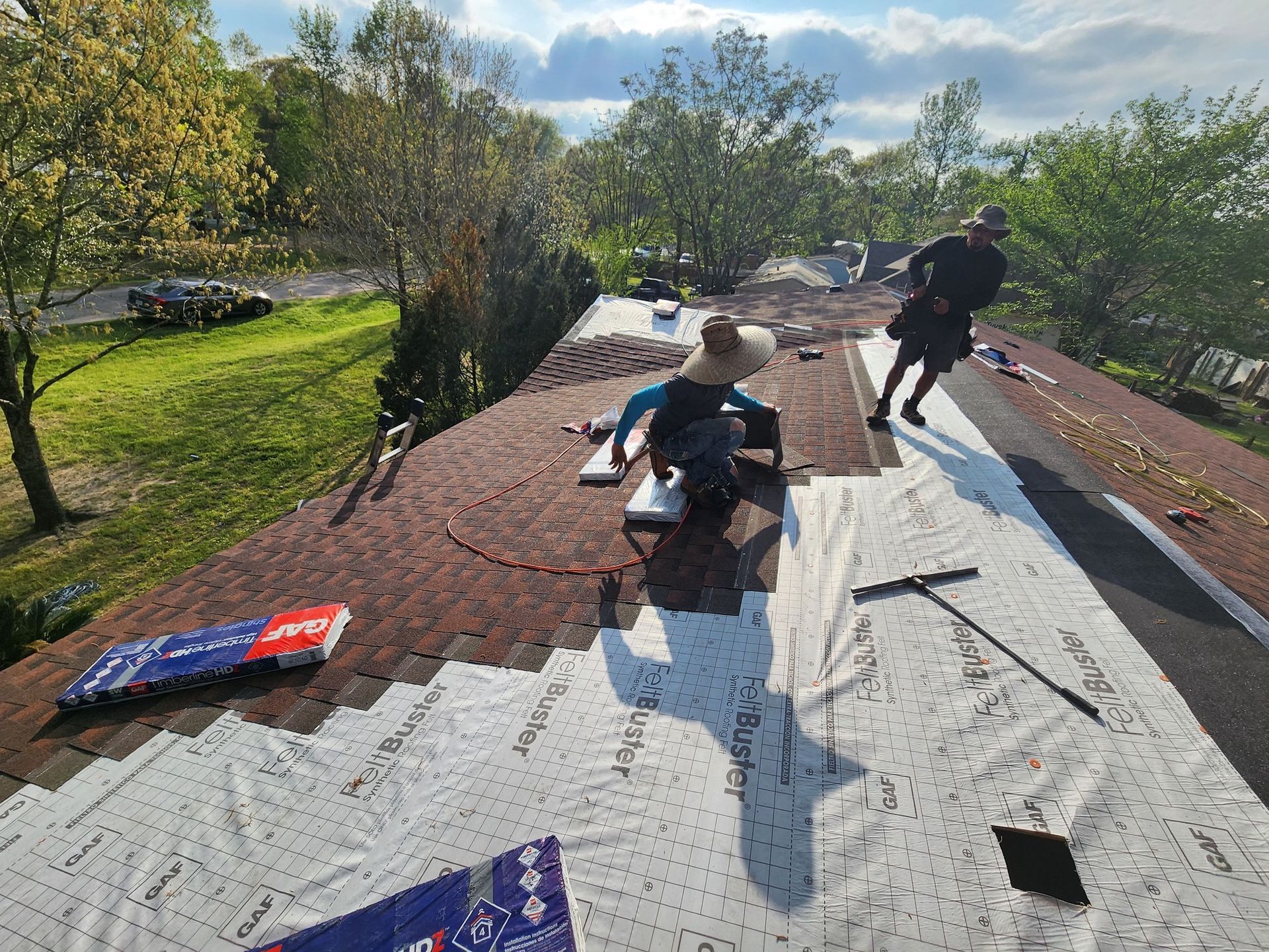 A group of people are working on a roof.