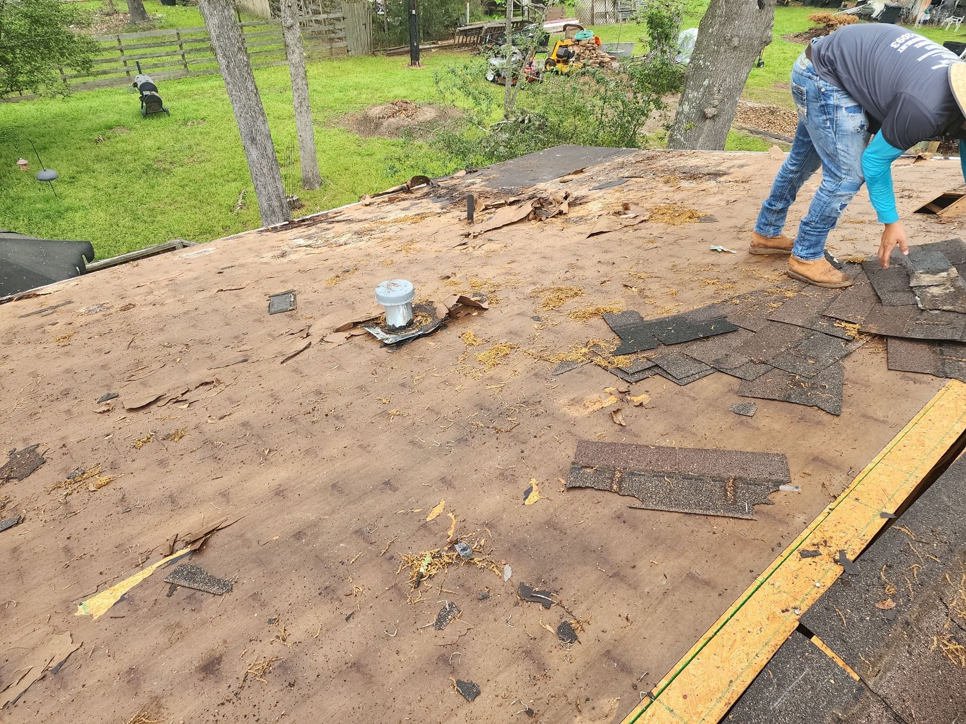 A man is working on the roof of a house.