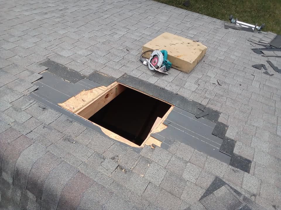 A hole in a roof with a circular saw in it