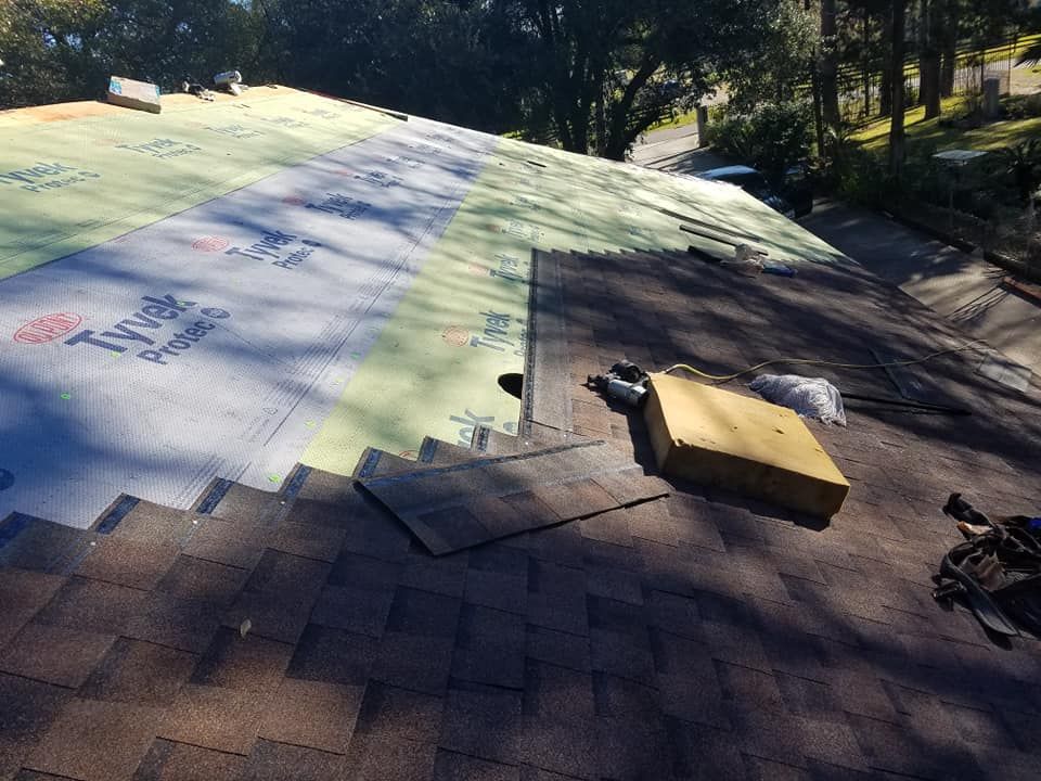A roof with a lot of shingles being installed on it.