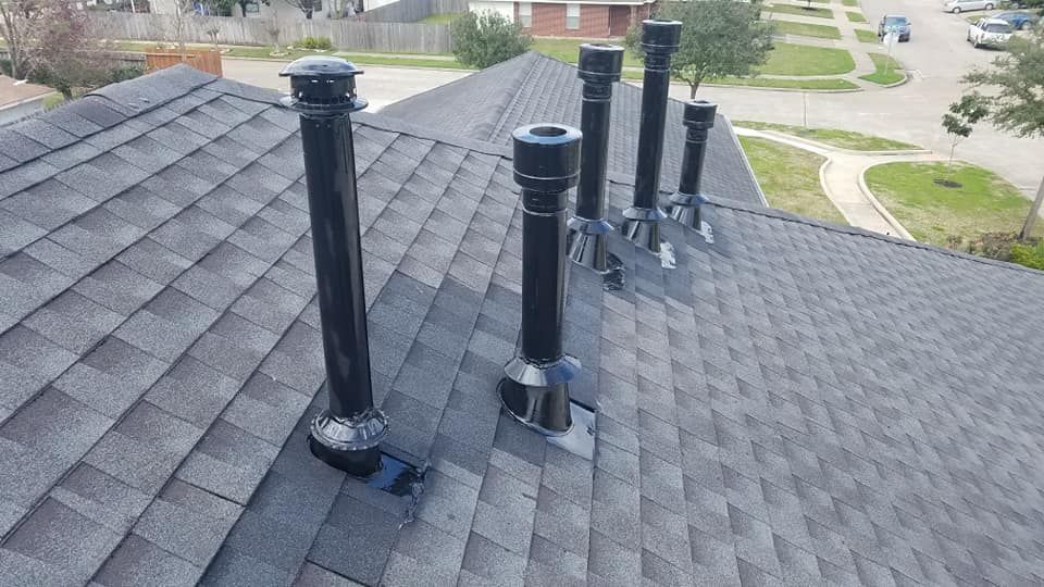 There are three chimneys on the roof of a house.