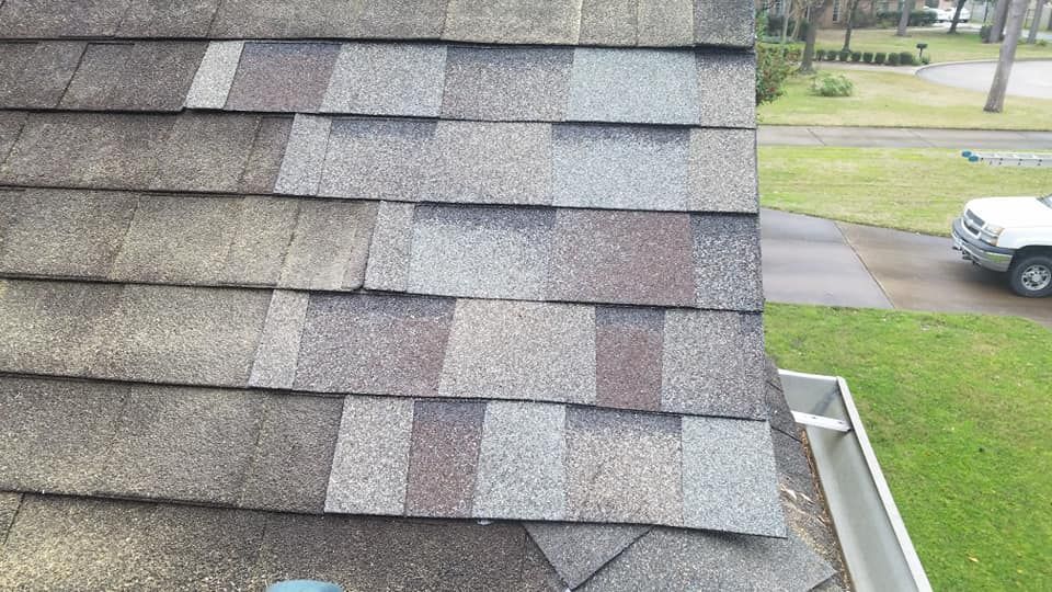 A white truck is parked on the side of a roof