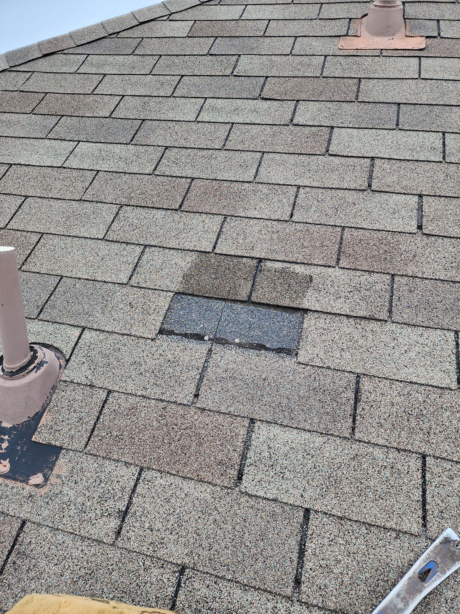 A roof with a lot of shingles and a ladder on it.