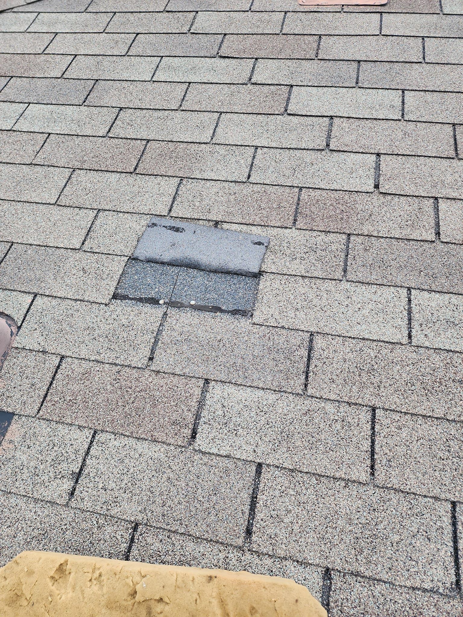 A close up of a brick floor with a piece of concrete on it.