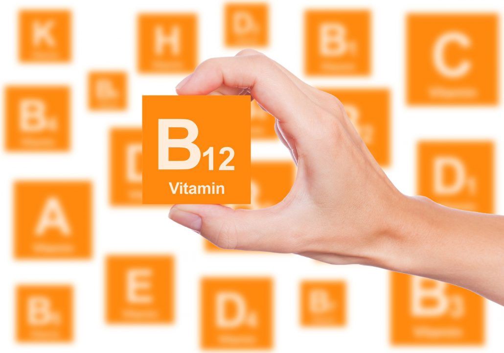 A person is holding a piece of paper with the word vitamin on it.