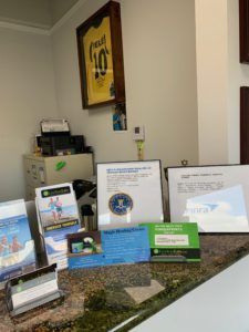 A reception desk with a yellow jersey on the wall.