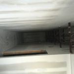 A room with a staircase going up to the ceiling.