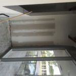 A room with a sliding glass door and a window.