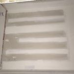 A white wall with a striped pattern on it.