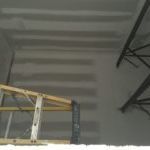 A ladder is hanging from the ceiling of a building.