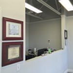 A dental office with two framed pictures on the wall.