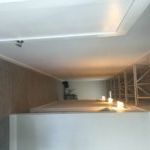 A room with a ceiling that is very high and a lot of shelves.