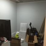 A room filled with boxes and a television.