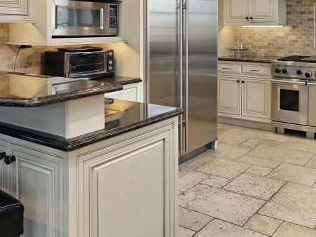 A kitchen with stainless steel appliances and white cabinets.
