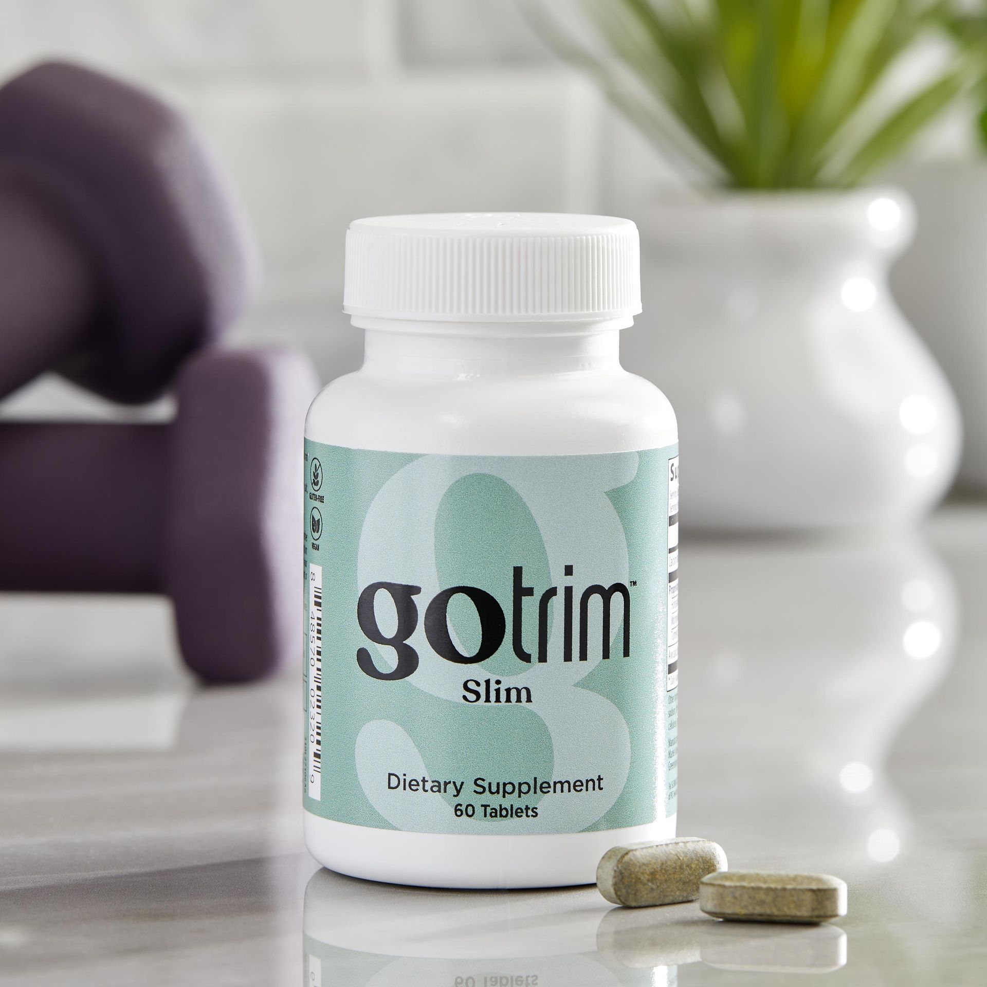 A bottle of gotrim slim dietary supplement sitting on a counter