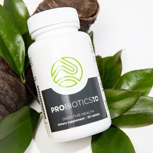A bottle of probiotics10 is surrounded by green leaves