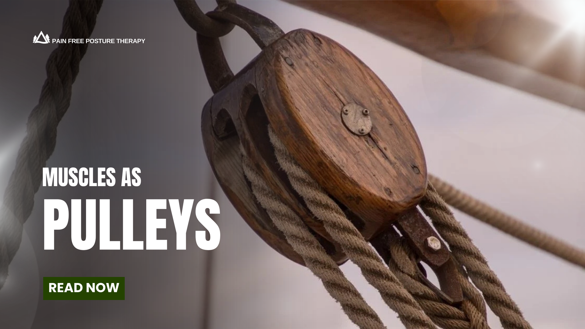 A close up of a pulley with a red rope attached to it.