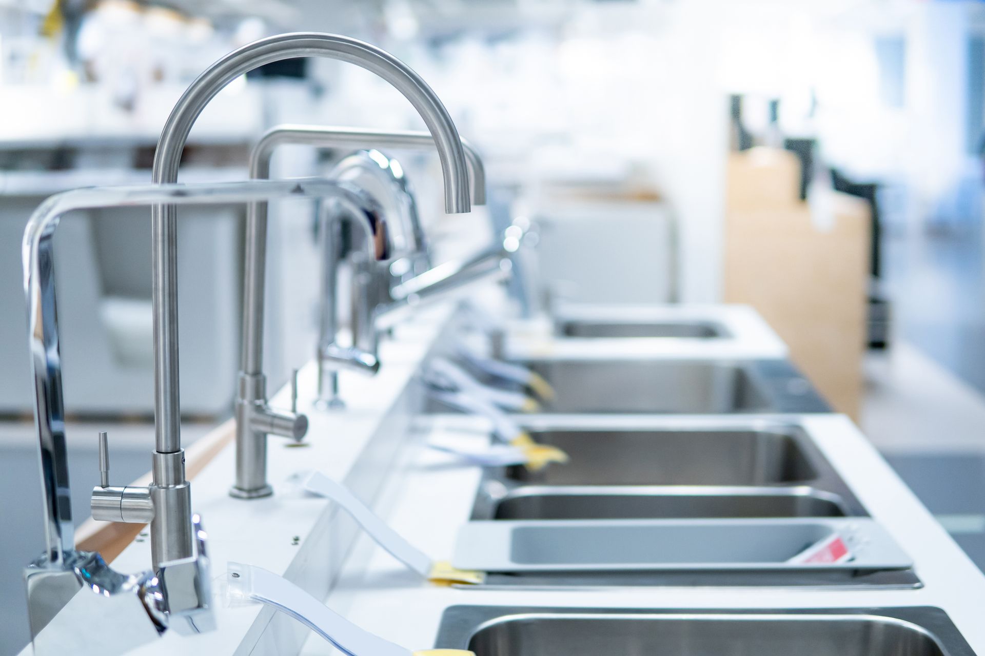 Modern stainless-steel commercial kitchen sinks with faucets and counters