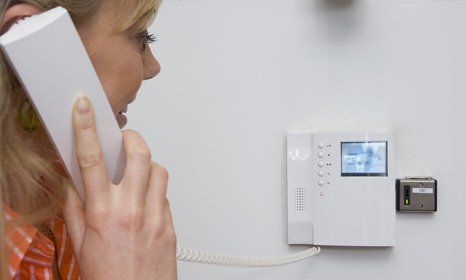 a lady using the phone entry with visual display