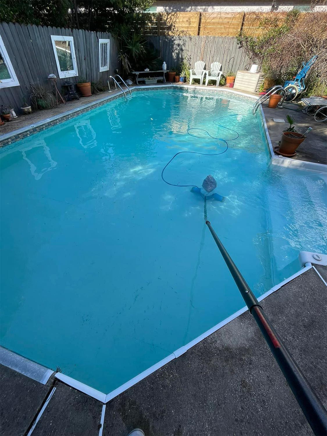 Pool Being Cleaned on a Sunny Day