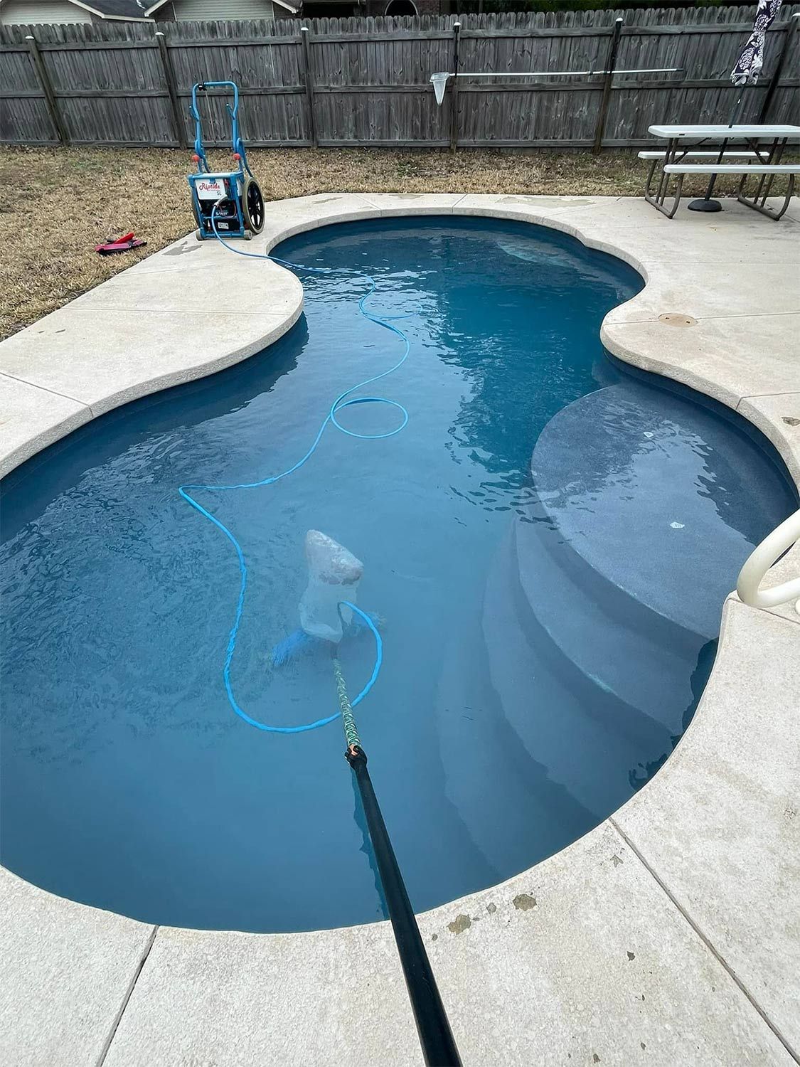Concrete Floor Surrounds the Backyard Pool