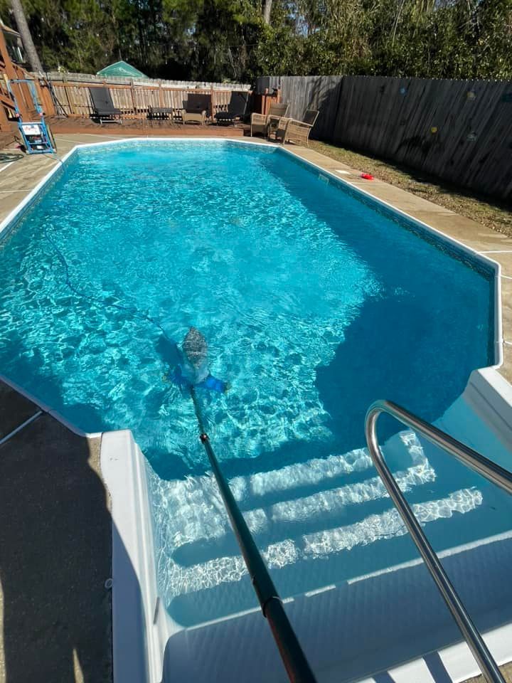Worker Cleaning a Residential Pool