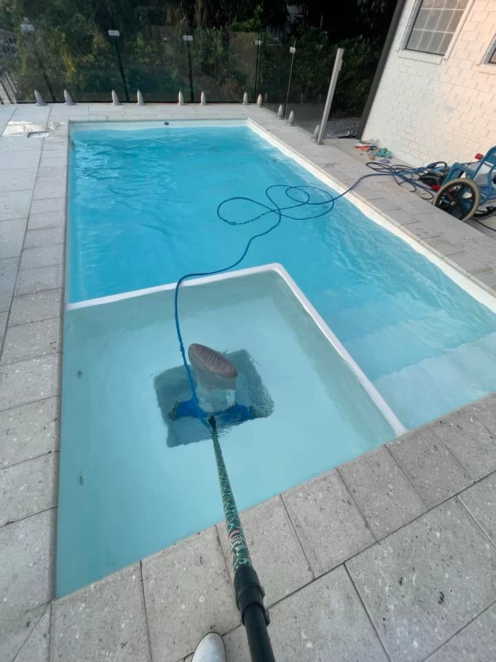 Pool Being Cleaned with a Vacuum