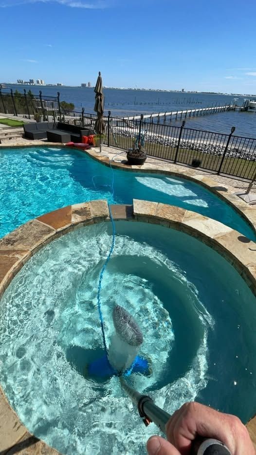 Worker Cleaning a Small Rounded Pool