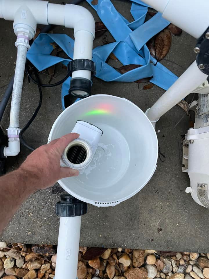 Worker Cleaning the Pool Filter Cartridge